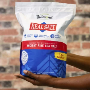 Bag of Real Salt ancient fine sea salt held by a person.