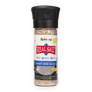 A spice grinder labeled Real Salt, containing coarse sea salt.