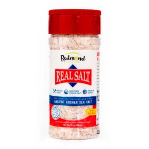 A container of Real Salt natural sea salt with a red cap.