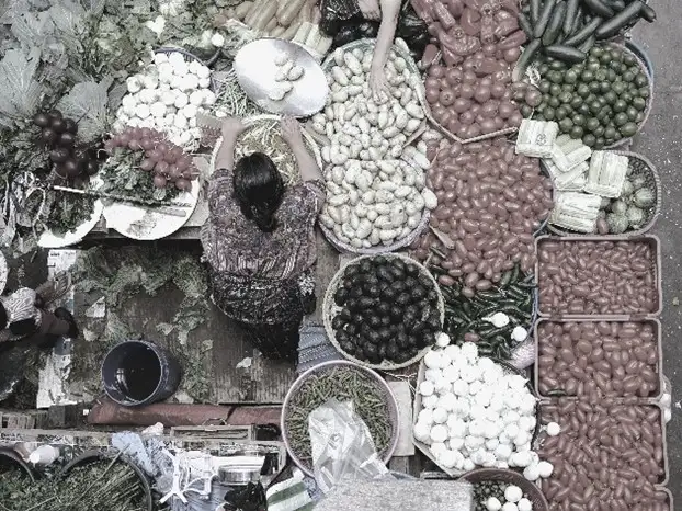 Top view of a market stall with various spices and goods.